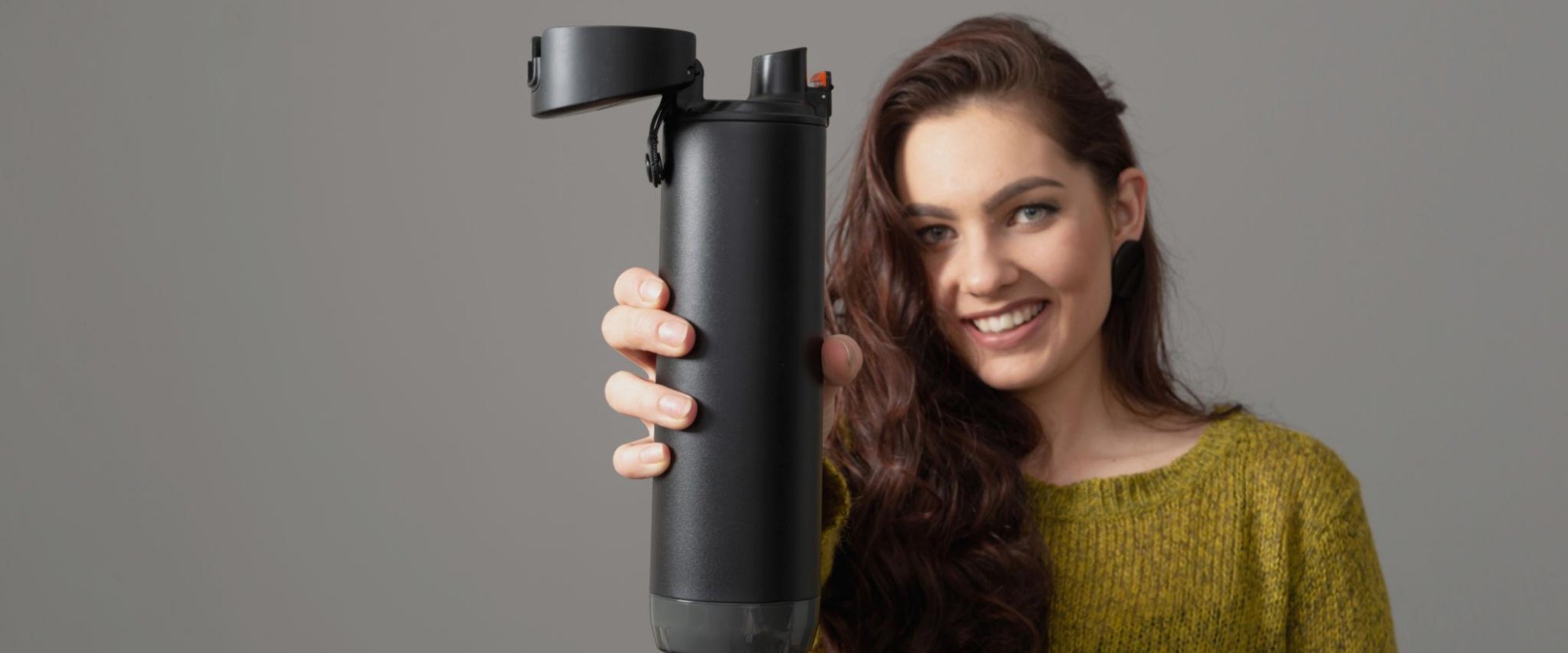 Smiling person holding the smart bottle