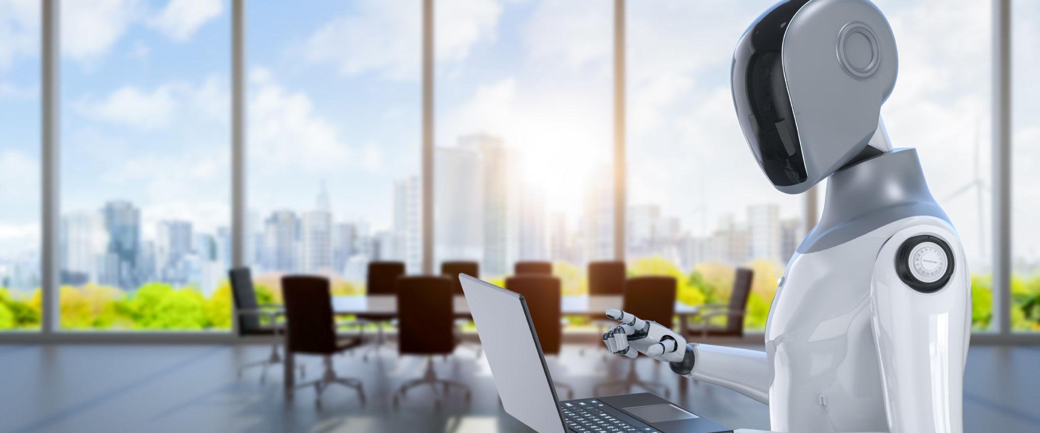 Humanoid robot working on a laptop in a modern office