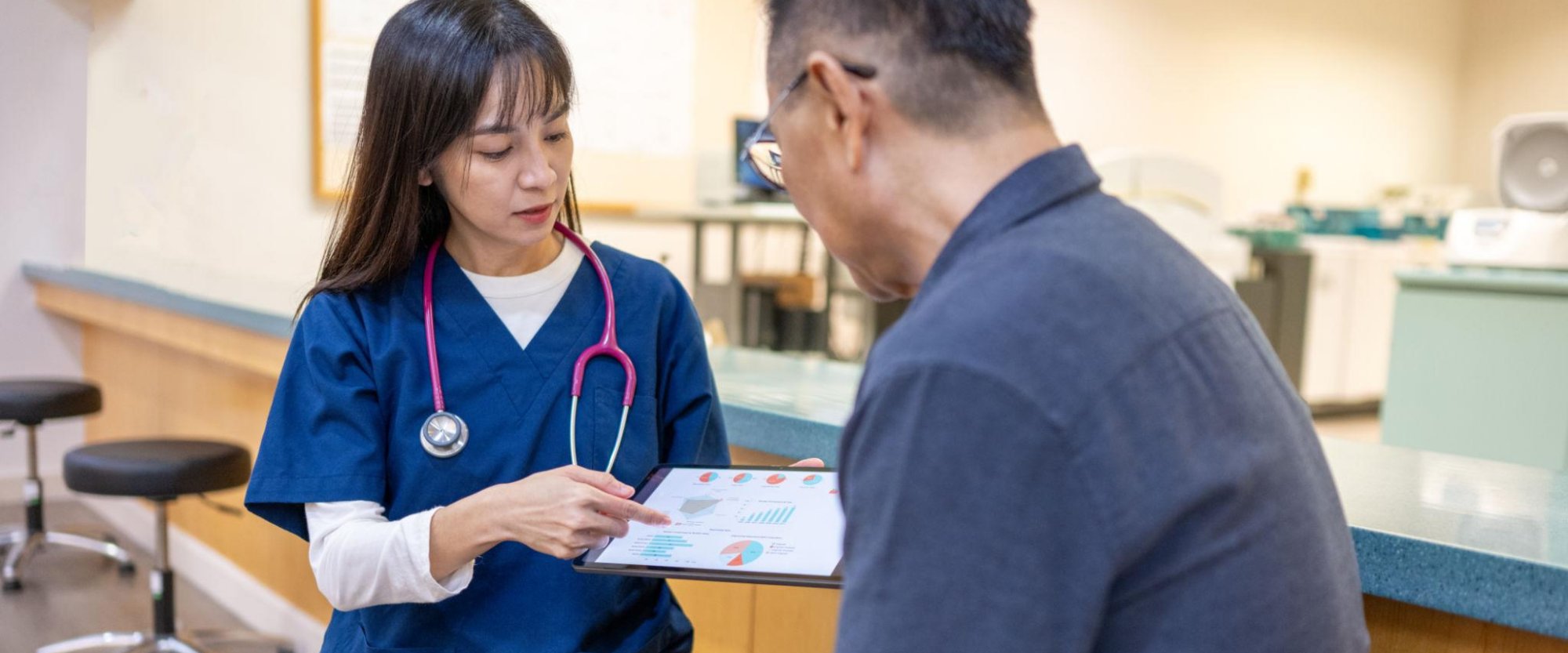 Nurse reviewing health charts with a patient